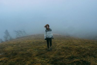 Full length of woman standing on field