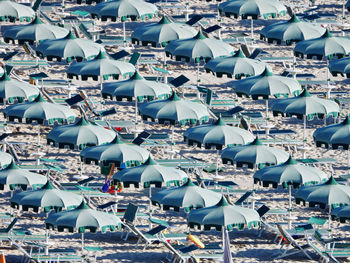 High angle view of parasols on beach during sunny day