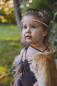 Cute baby dressed in the clothes of primitive people