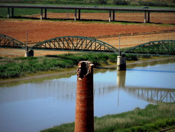 High angle view of broken column against railway bridge over river