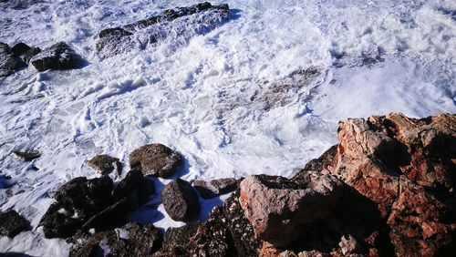 High angle view of rocks in sea