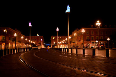 Illuminated light trails against clear sky at night