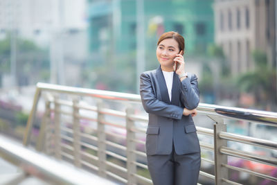 Full length of a young woman using mobile phone