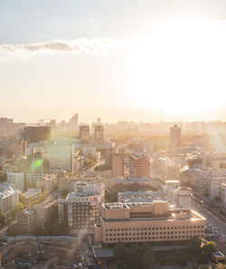 Buildings in city against sky during sunset