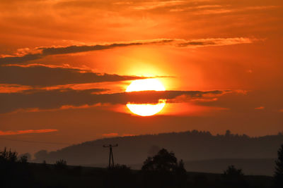 Scenic view of silhouette landscape against romantic sky at sunset