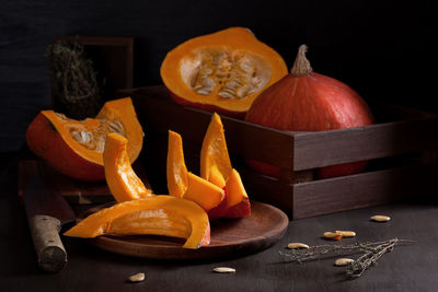 Close-up of pumpkin on table against black background