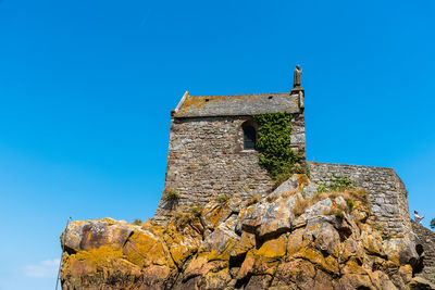 View of hermitage at mont saint-michel against sky