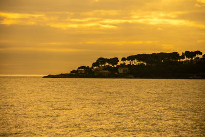 Scenic view of sea against orange sky