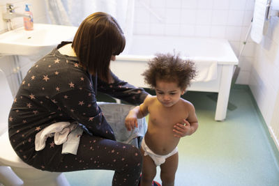 Mother with daughter in bathroom