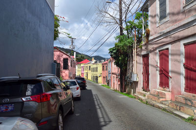 Cars on street amidst buildings in city