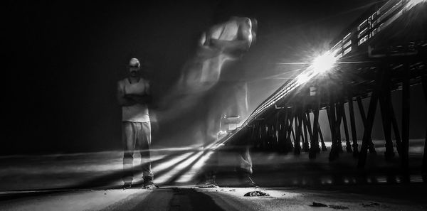 Low angle view of illuminated street at night