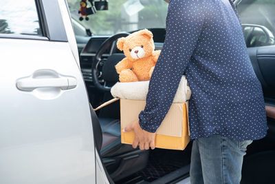 Rear view of man standing in car