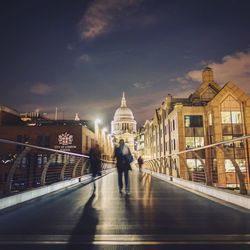 People walking in illuminated city