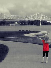 Bridge over river against cloudy sky