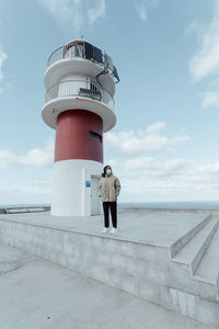 Woman standing in front of lighthouse