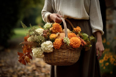 Midsection of woman holding bouquet