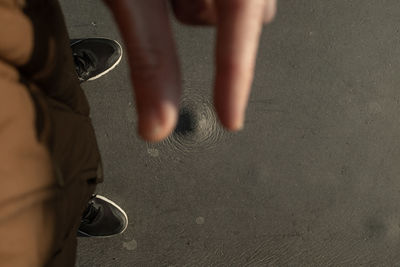 Low section of man walking on street