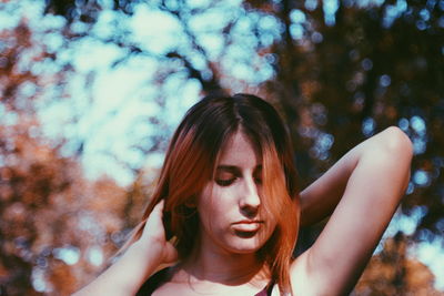 Portrait of woman looking at tree