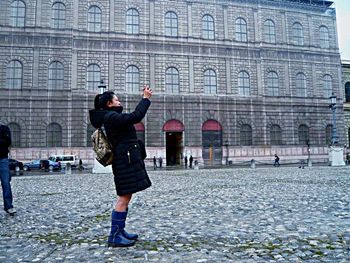 WOMAN WALKING ON CITY STREET