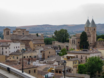 Buildings in town against sky