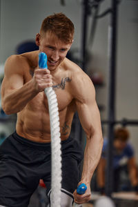 Midsection of man exercising in gym