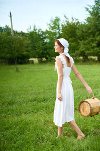 Full length of woman standing on field