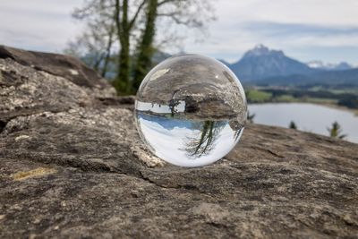 Close-up of crystal ball on rock