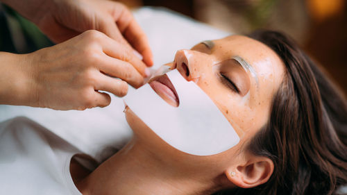 Woman with skincare face mask in beauty salon