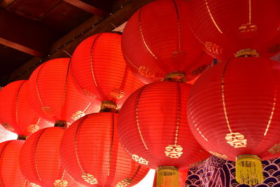 Low angle view of illuminated lanterns hanging in row