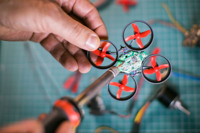 Close-up of hand assembling drone