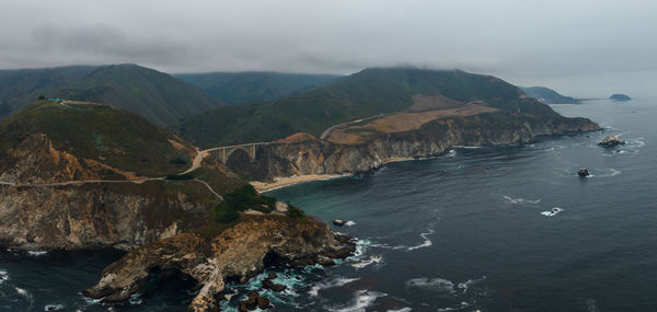 Scenic view of sea and mountains against sky