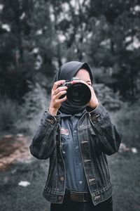 Young woman photographing through camera