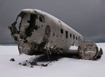 Abandoned airplane on snow covered land