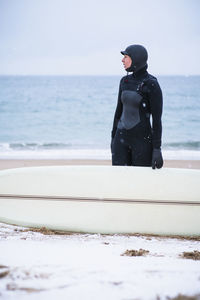 Young woman going winter surfing in snow