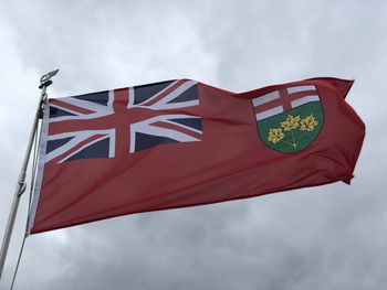 Low angle view of ontario flag against sky