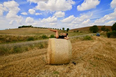 Hay bales on field against sky