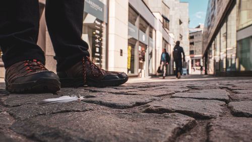 Low section of people walking on street