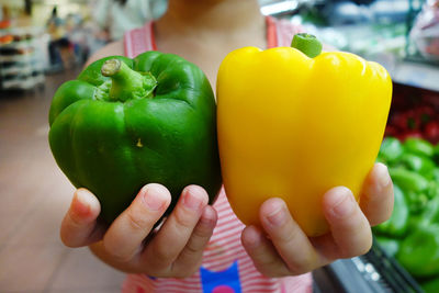 Close-up of cropped hand holding lemon