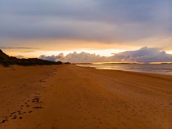 Scenic view of beach against sky during sunset