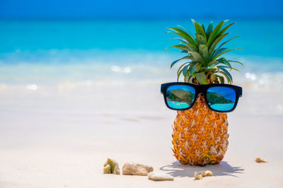 Close-up of sunglasses on beach