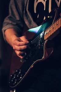 Close-up of man playing guitar