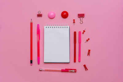 Directly above shot of pink pencils against colored background