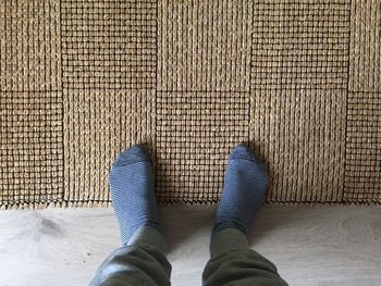 Low section of woman standing on tiled floor