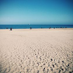 Scenic view of beach against blue sky