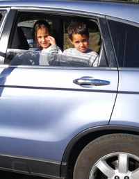 Portrait of happy boy on car