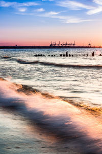 Scenic view of beach against sky during sunset