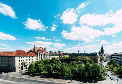 View of cityscape against cloudy sky