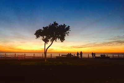 Silhouette of people at sunset