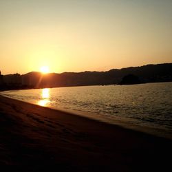 Scenic view of sea against clear sky during sunset