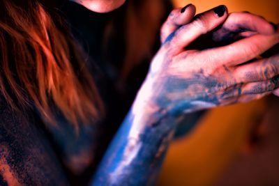 Midsection of woman with powder paint on hands